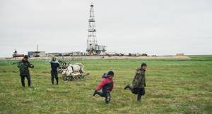 Stammler - Children from camp 2 playing on a pasture close to an oil rig on the Toravei deposit Nenets AO Barents Region Russia