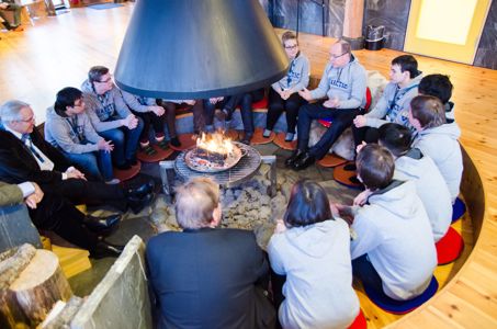 UArctic Student Ambassadors gather around fire with Prince Albert II of Monaco