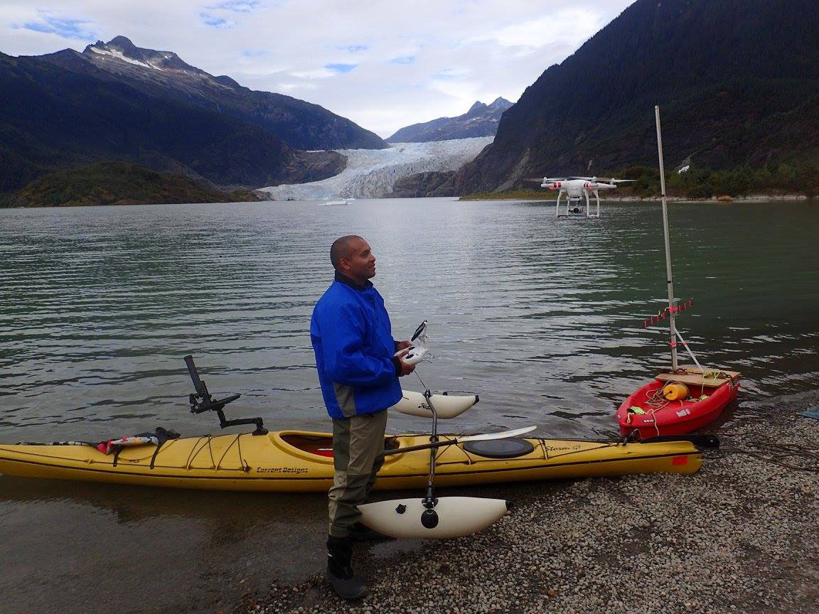 Court Pegus tests a Phantom 4 drone with Mendenhall Glacier in the background. Pontoon stabilizers were added to his kayak to help it serve as a drone launching pad